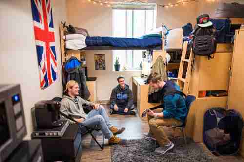 Students play guitar and talk in a holton-hooker dorm room